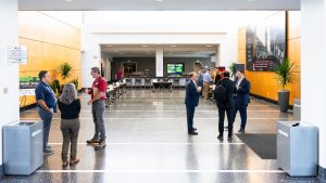 Attendees at the ReCell meeting standing in the building lobby
