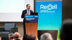 Krishnamoorthi speaks at a podium during the ReCell event.